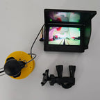 Fishing camera kit with its monitor powered on and cable reel beside it