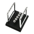 Newton's cradle desk display showing compact and large footprint choices for comparison