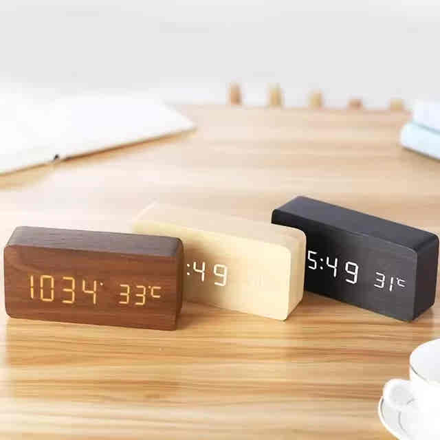 Wooden digital alarm clock for bedside time checks, with an amber LED display and natural wood exterior — Gearfinch