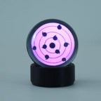 Sharingan Bluetooth speaker with touch wheel controls for music on a desk setup