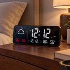 Black Dayview clock at reduced brightness on a bedside table