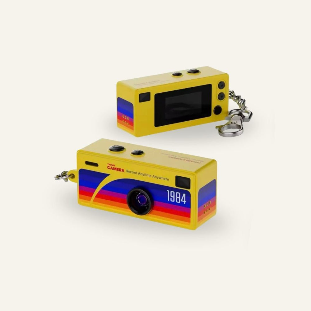Yellow G6 keychain digital camera shown from the front and rear