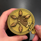 Closed antique gold-tone snake ring box held in a hand for scale