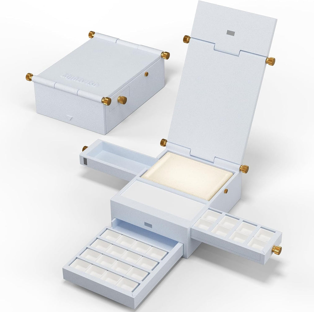 White Field Studio travel watercolor palette shown open and closed, with 24 empty pans and two ceramic mixing surfaces.