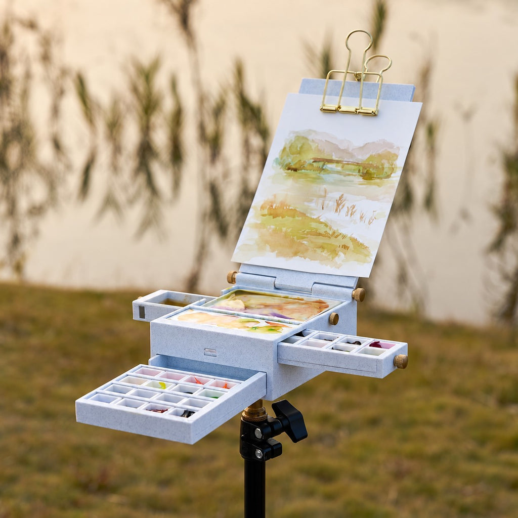 Field Studio watercolor palette used on a tripod outdoors; paint, paper, clip and tripod shown separately