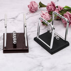 Compact Black base Newton's cradle desk display, 9 × 7.5 × 9.5 cm, for small workspaces