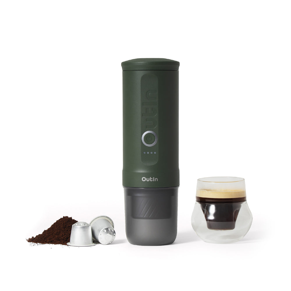 Forest Green OutIn Nano 2 espresso machine beside coffee and capsules