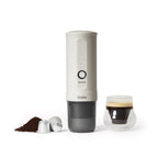 Pearl White OutIn Nano 2 portable espresso machine beside an espresso