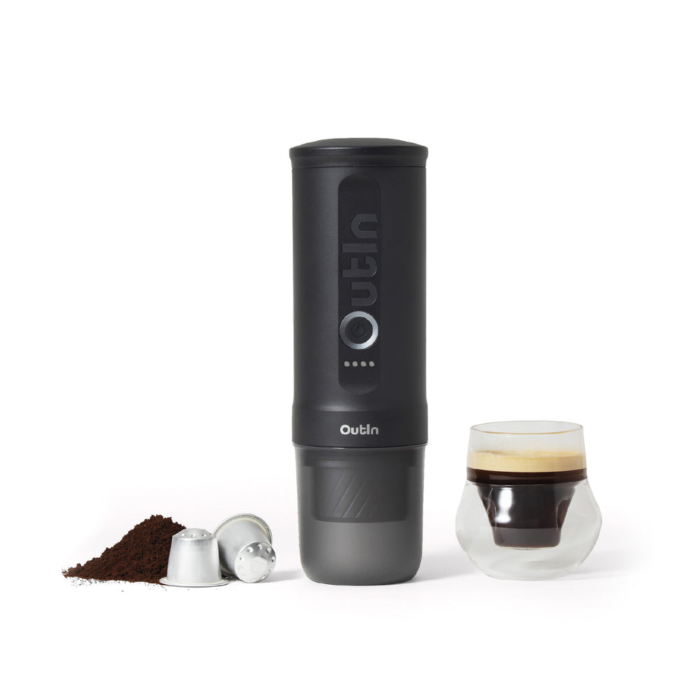 Space Gray OutIn Nano 2 portable espresso machine beside an espresso
