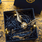 Gold wing Golden Snitch ring box with wand-shaped key for an engagement ring proposal reveal