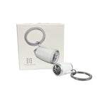 Small jet engine keychain with chrome-colored inlet trim and movable fan blades