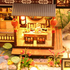 DIY forest habitat miniature showing the furnished patio seating and outdoor dining area beside the garden
