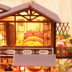 Two-level forest habitat miniature kit with living and dining areas below and a bedroom upstairs
