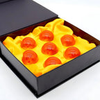 Close-up of polished orange spheres with internal star patterns