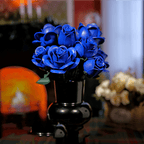 Twelve blue rose building flowers with adjustable stems for arranging in a 3 to 6 inch vase