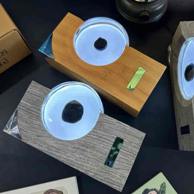 Ferrofluid rhythm lamp for a gaming desk, available in Gray and Tan wood-grain ABS finishes — Gearfinch