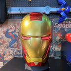 Gold Mark 46 motorized Iron Man helmet arranged as a collector display centrepiece