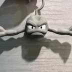 Novelty Geodude clothes hanger for lightweight coats in an anime fan bedroom or dorm closet