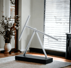 Kinetic sculpture with two counterweighted aluminium arms for mechanically curious desk owners