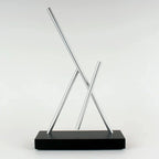 Swinging Sticks kinetic sculpture for shelf decor with slow, never-repeating movement