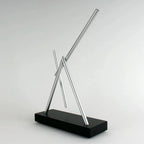 Electromagnetic desk sculpture that turns a still workspace into a slow-moving display