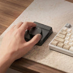 Hand using the creative dial beside a keyboard
